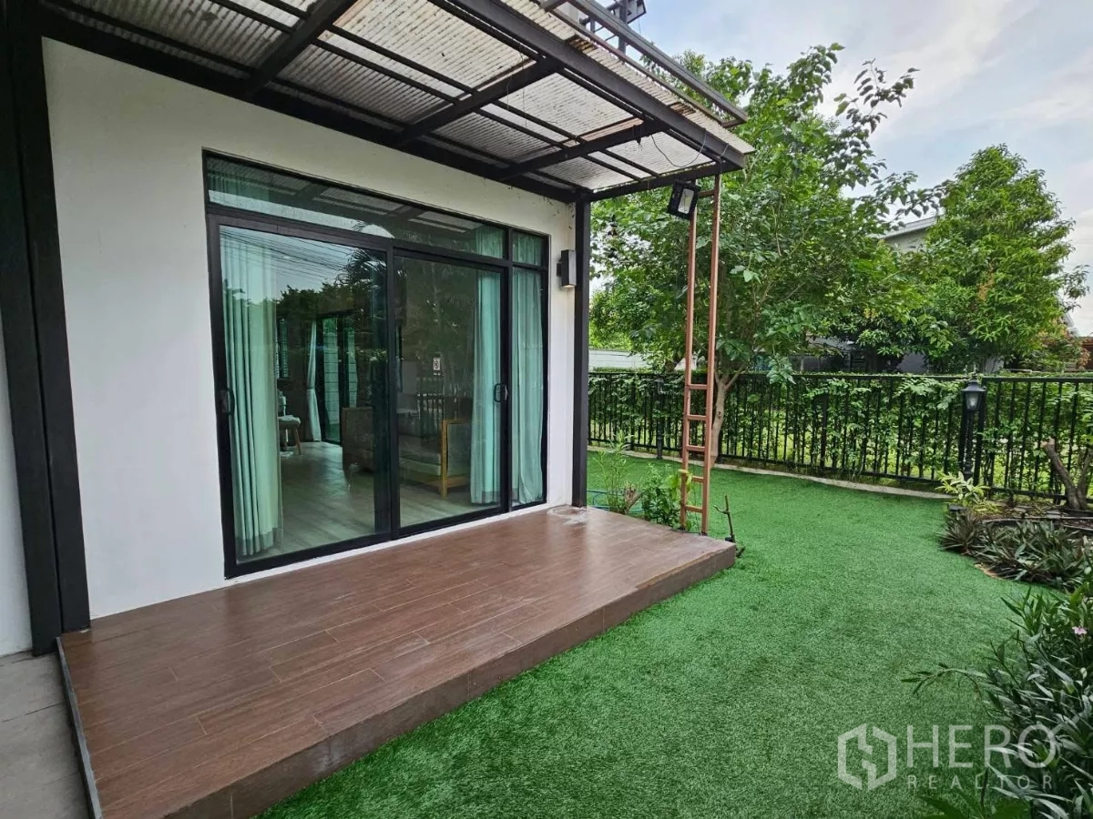 Detached House for rent or sale in Don Mueang, Bangkok - Sliding glass doors opening to an elevated deck and wraparound garden.