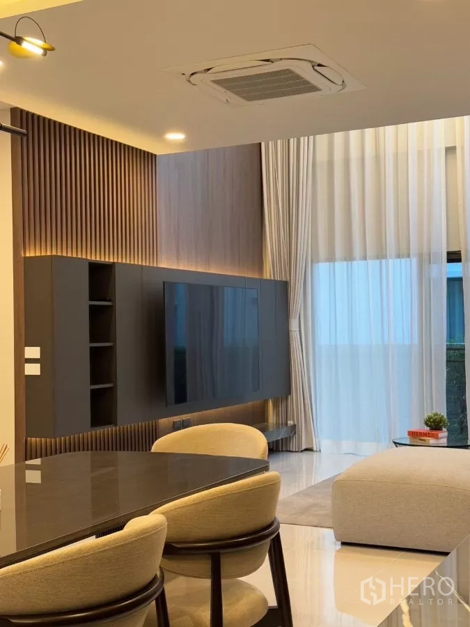 Detached House for rent in Bang Phli, Samut Prakan - Close-up of TV feature wall and dining chairs under coffered ceiling lights