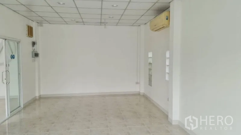 Shophouse for rent - Interior with white walls, tiled floor, drop ceiling and wall air conditioner