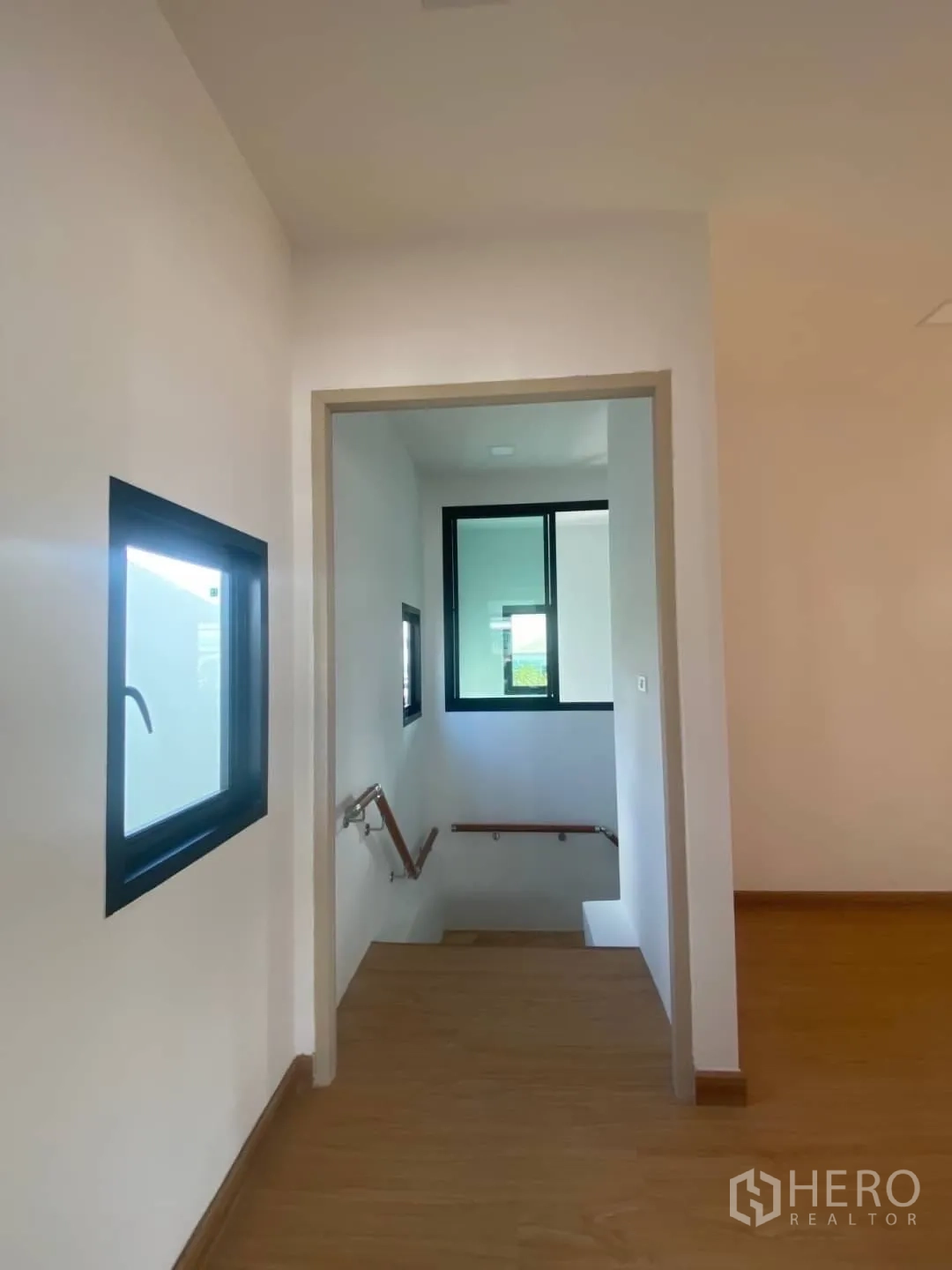 Home Office for sale - Upper-floor landing with windows and access to the staircase.