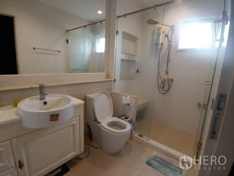 Detached House for sale in Khlong Sam Wa, Bangkok - Bathroom featuring a glass-enclosed shower, vanity, and toilet.