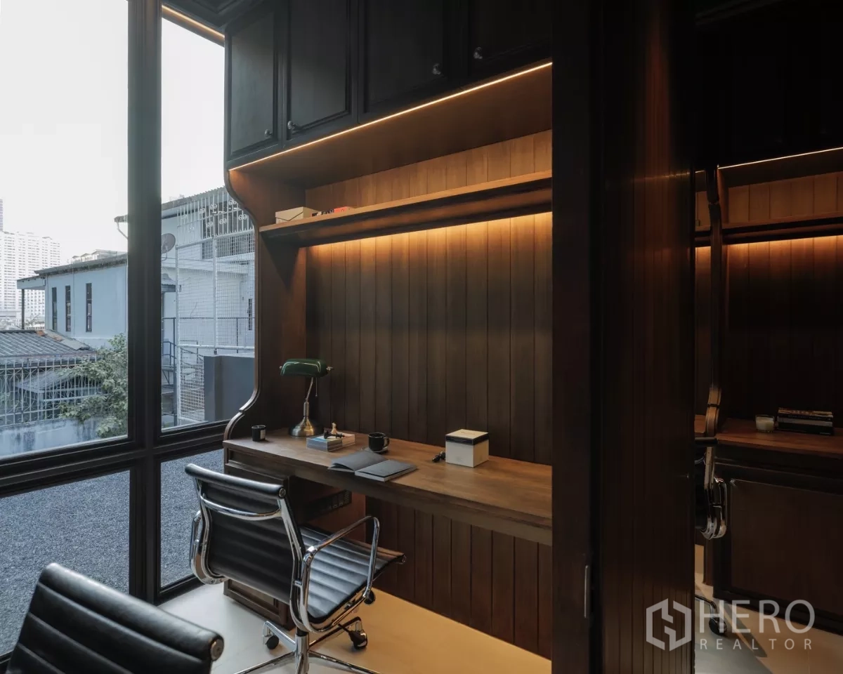 办公空间 出租在Bang Rak, Bangkok - 转角工位，内置层架、台灯与城市景观