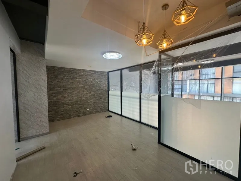Home Office for rent - Office zone with a stone feature wall, pendant lights and frosted glass partitions.