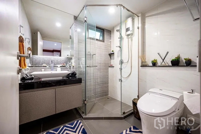 Detached House for sale in Prawet, Bangkok - Modern bathroom with glass shower enclosure and vanity.