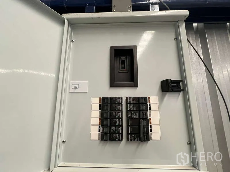 Warehouse for rent in Lat Krabang, Bangkok - Industrial electrical breaker panel open to show switches inside the warehouse.