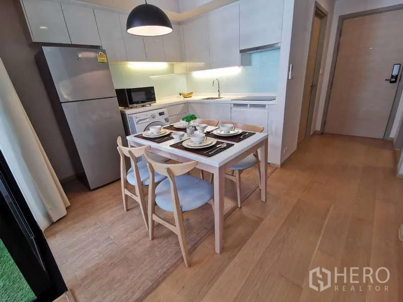 คอนโด ให้เช่าหรือขายในWatthana, Bangkok - ครัวแบบเปิดพร้อมตู้ลอยสีขาว โต๊ะทานข้าวสี่ที่ และเครื่องใช้ไฟฟ้าครบ