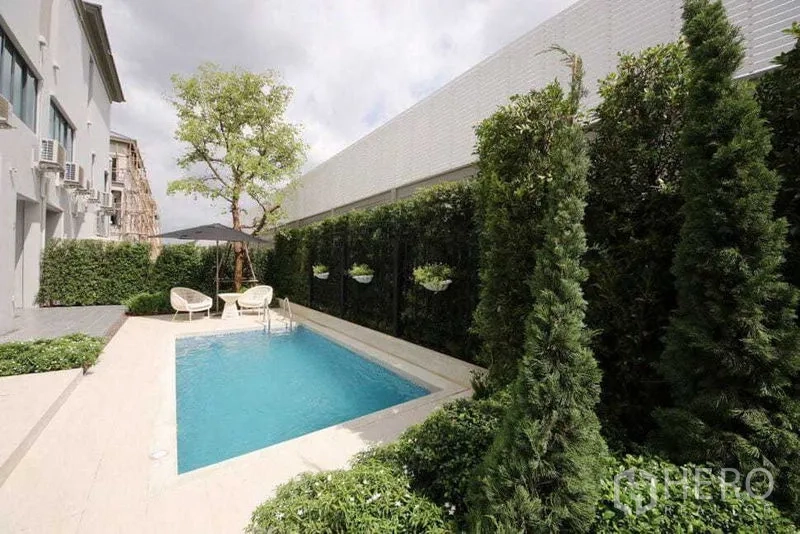 Detached House for sale in Prawet, Bangkok - Private courtyard plunge pool surrounded by tall hedges and seating.
