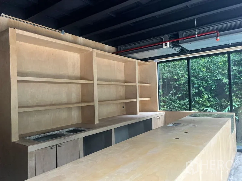 พื้นที่ขายปลีก ให้เช่าในWatthana, Bangkok - ภาพใกล้ของเคาน์เตอร์และชั้นวางไม้ใต้เพดานเปิดโล่ง ข้างหน้าต่างบานใหญ่