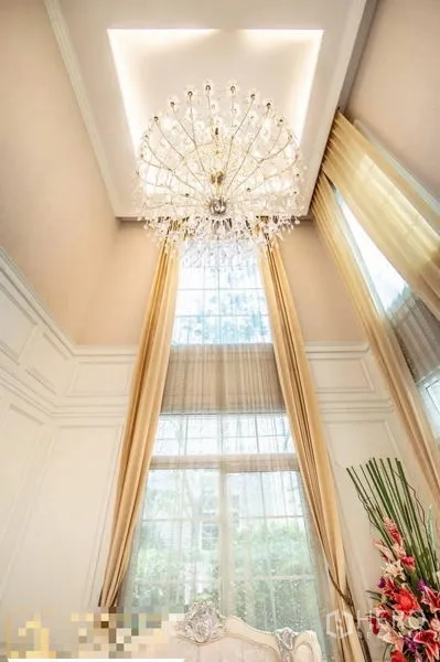 Detached House for rent or sale in Bang Phli, Samut Prakan - Close view of crystal chandelier and floor‑to‑ceiling windows with gold drapes.