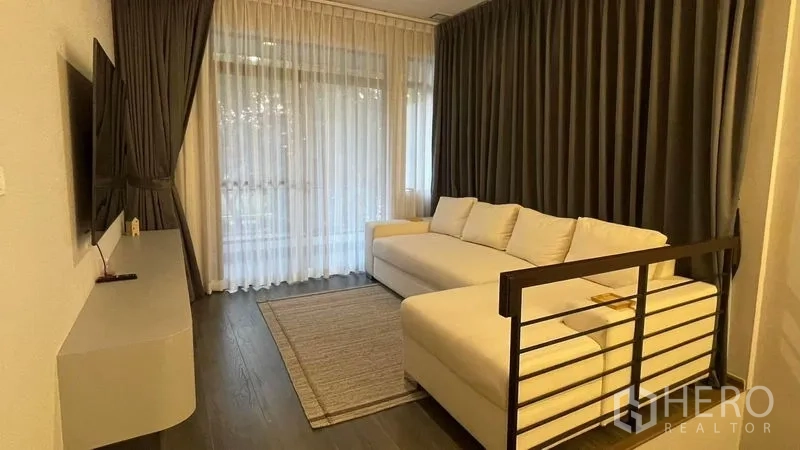 Detached House for rent in Bang Phli, Samut Prakan - Upstairs family lounge with white sectional sofa and curtains