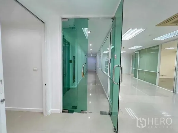 Office Space for rent in Wang Thonglang, Bangkok - Entrance corridor featuring full-height green-tinted glass doors and side panels.