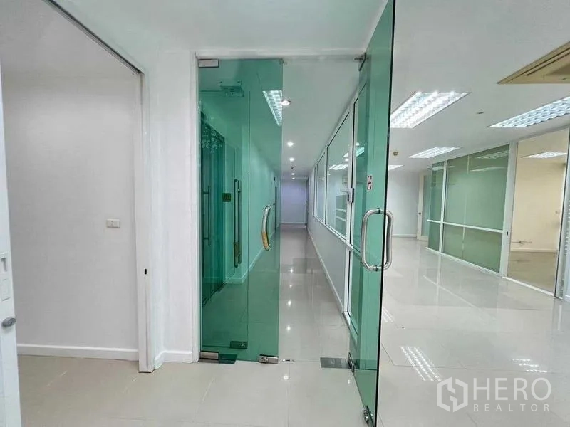 Office Space for rent in Wang Thonglang, Bangkok - Entrance corridor featuring full-height green-tinted glass doors and side panels.