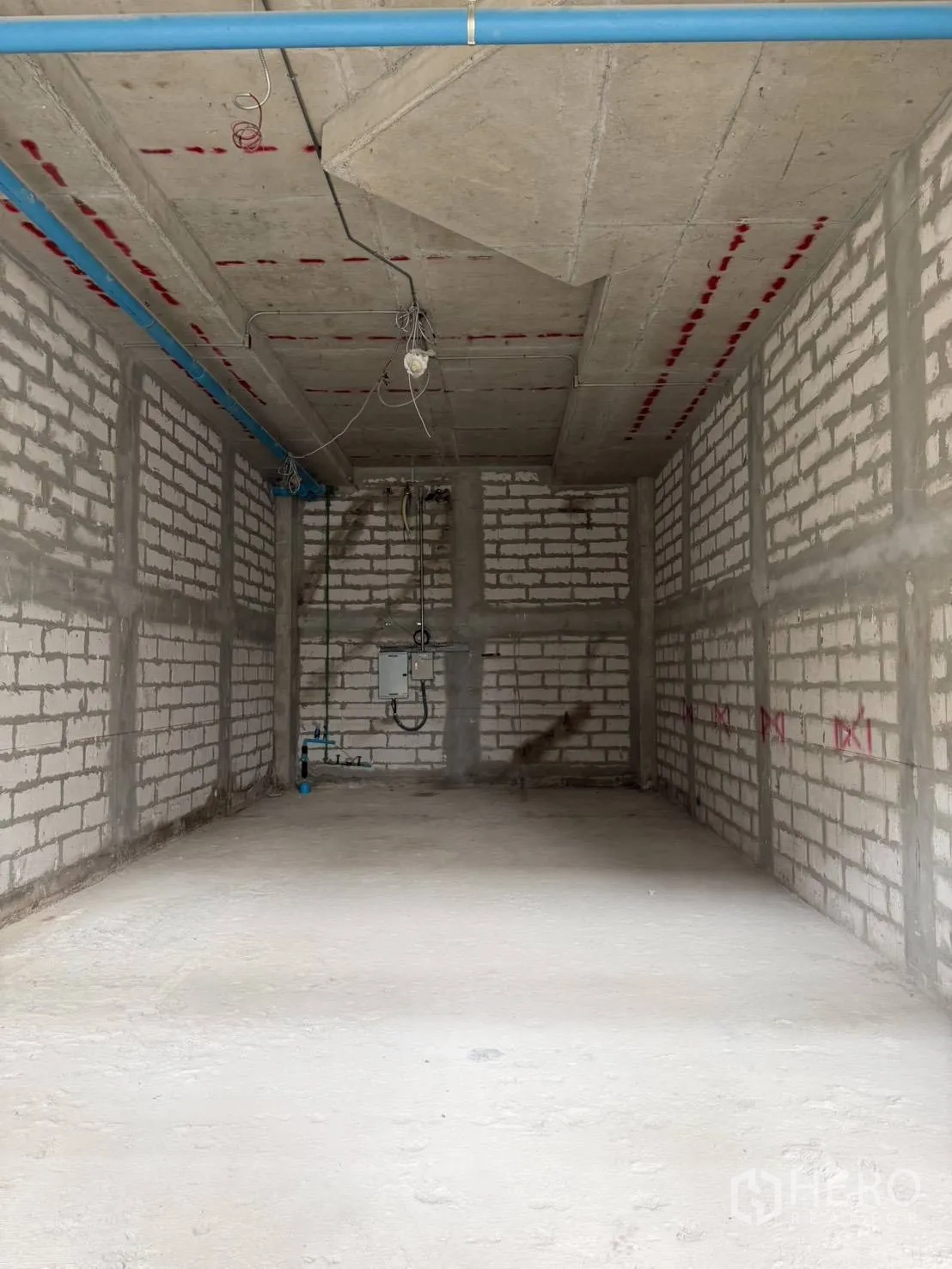 Retail Space for rent in Khlong Toei, Bangkok - Unfitted retail unit with bare brick walls, concrete floor and exposed ceiling pipes.