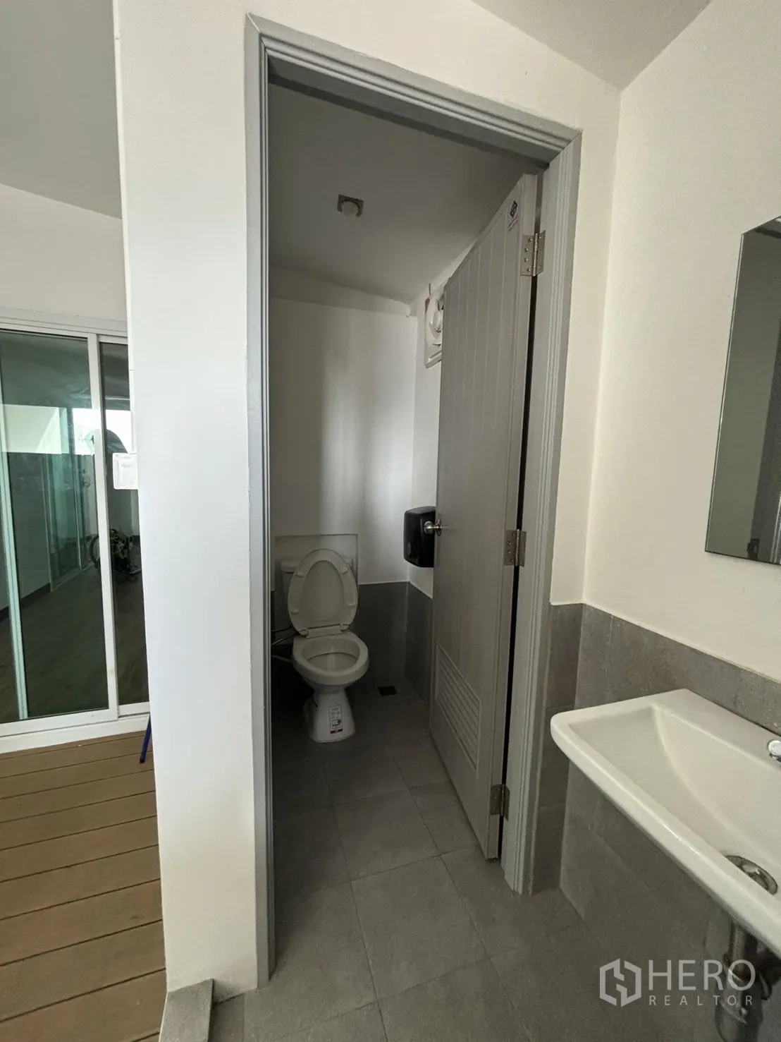 Office Space for rent in Watthana, Bangkok - Clean restroom with a sink and toilet beside the corridor.