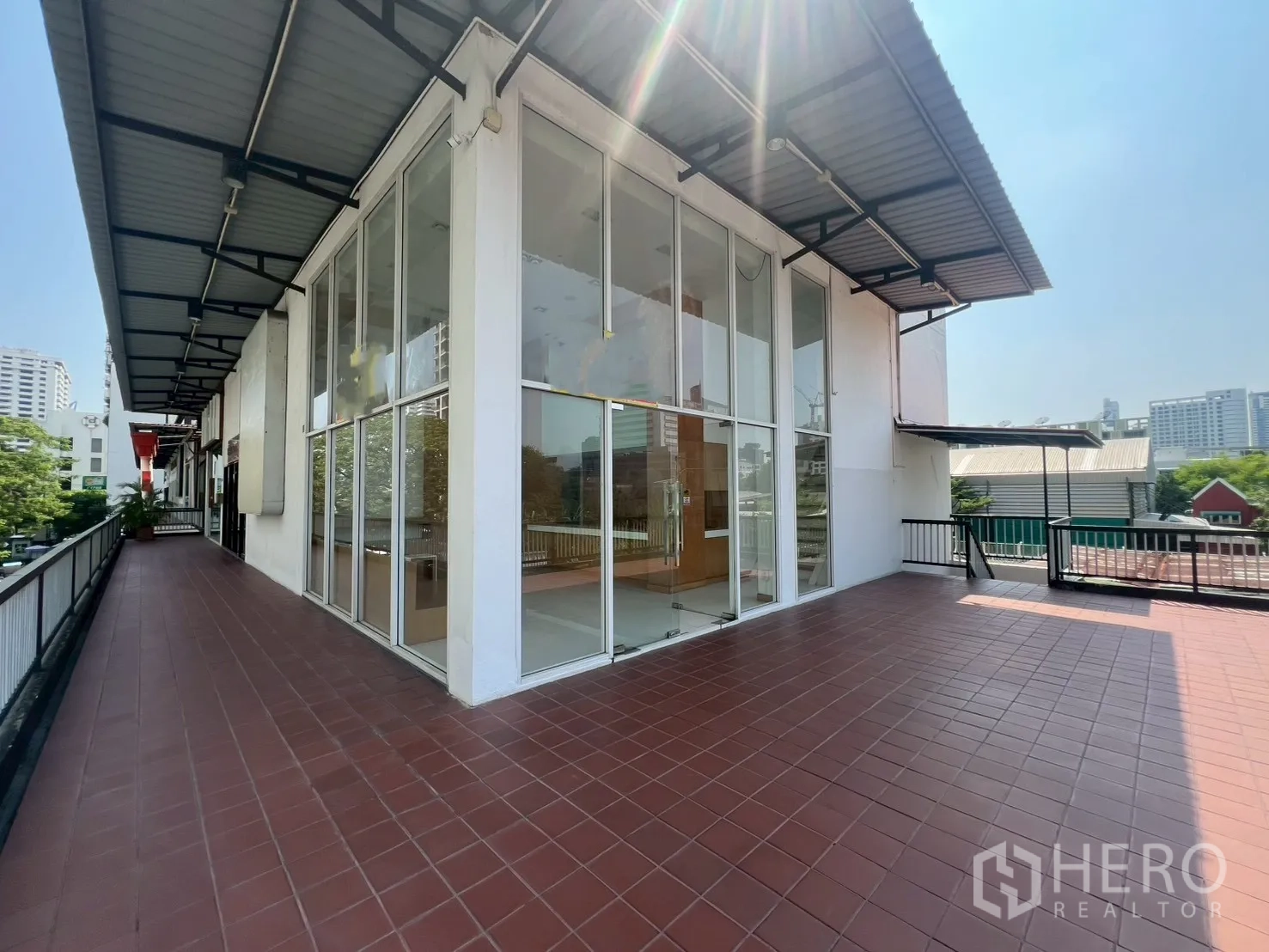 พื้นที่ขายของ for rent in Watthana, Bangkok - มุมภายนอกของยูนิตพร้อมผนังกระจกสูงและชานระเบียงคลุมหลังคากว้าง