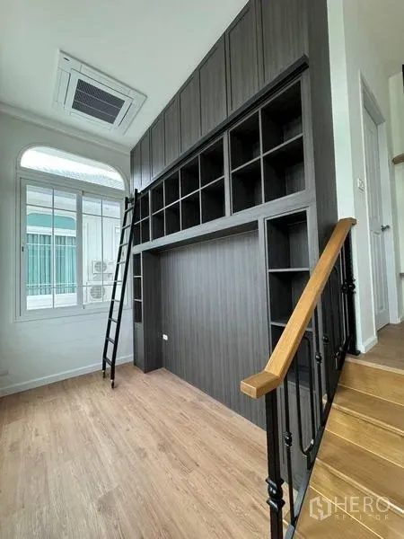 Detached House for rent - Landing area with tall dark cabinetry, ladder and large window
