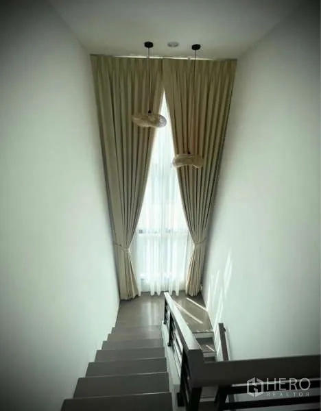Detached House for rent in Bang Phli, Samut Prakan - Staircase with tall window, pendant lights and natural daylight.