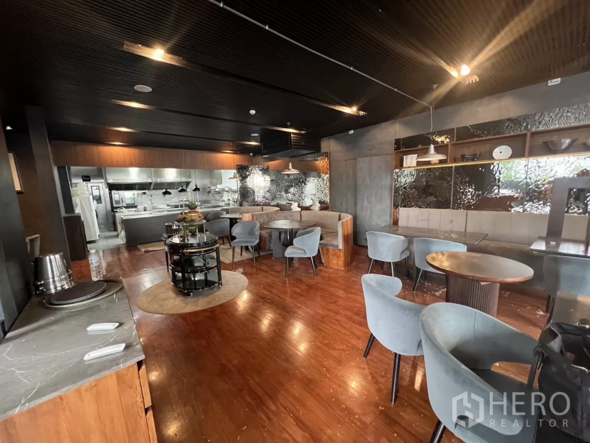 Retail Space for rent - Wide view of a fitted restaurant interior with booths and an open kitchen.