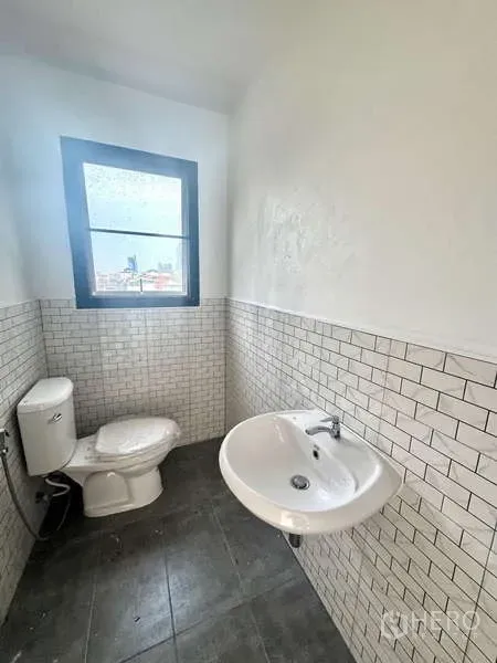 Office Space for rent in Bang Rak, Bangkok - Private restroom featuring a window, white subway tiles, and ceramic fixtures.
