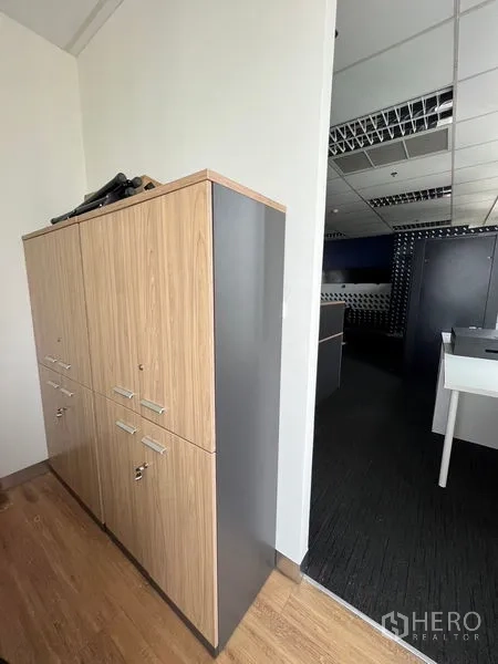 Office Space for rent in Huai Khwang, Bangkok - Tall wood and gray storage cabinets in the corridor of a modern office.