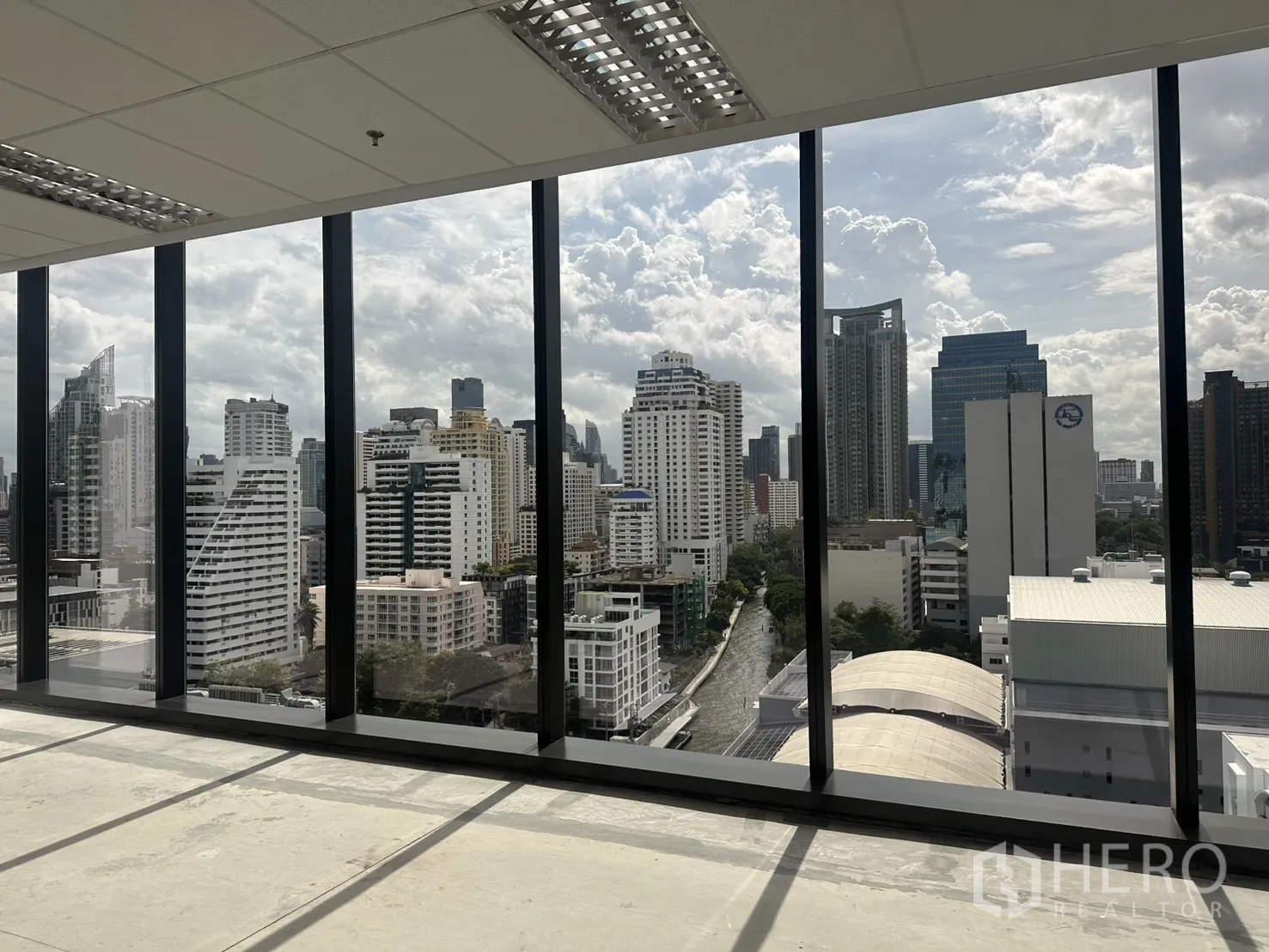 Office Space for rent in Ratchathewi, Bangkok - Panoramic city view through tall glass windows from the office interior.