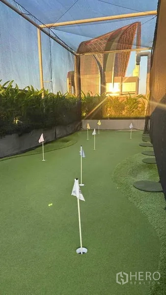 Condominium for sale - Rooftop putting green practice area at the condominium during sunset.