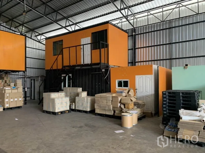 Warehouse for rent in Bang Kapi, Bangkok - Mezzanine container-style office units inside the warehouse with stair access for administration.