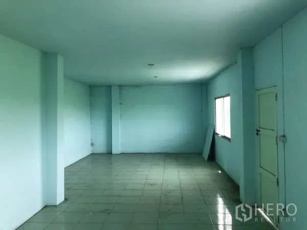 Warehouse for rent in Nonthaburi - Upstairs tiled office room with window and internal door inside the warehouse.