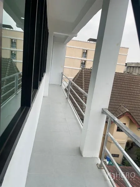 Home Office for rent or sale in Wang Thonglang, Bangkok - Narrow balcony walkway with metal railings beside windows.