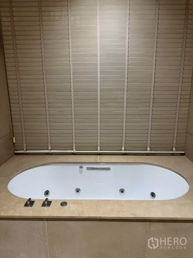 公寓 出租在Sathon, Bangkok - 浴室内置椭圆按摩浴缸，石材台面包围。