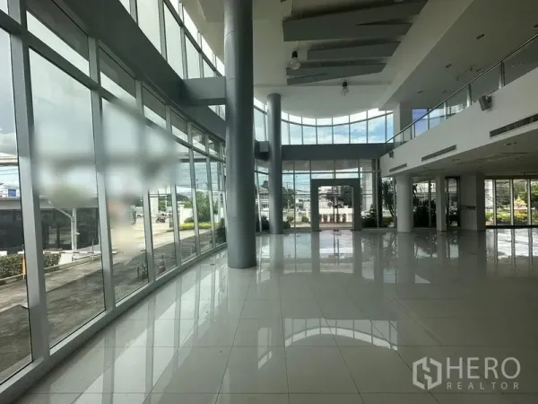 Retail Space for rent in Prawet, Bangkok - Double-height glass atrium with curved facade and glossy white tiles, ideal for a showroom entrance.