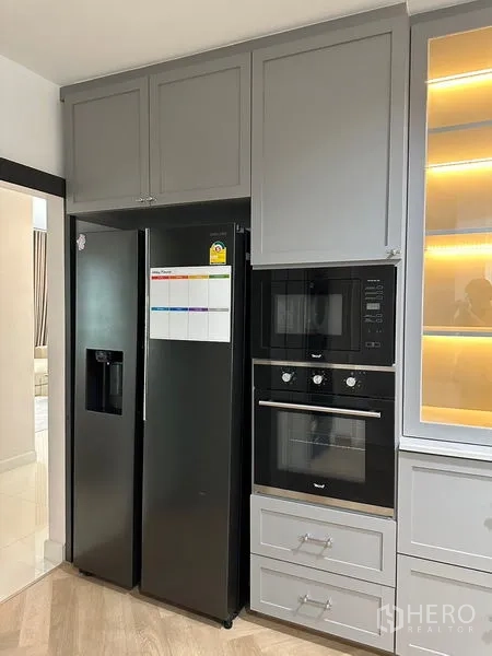 Detached House for rent or sale - Tall pantry wall with side-by-side refrigerator and built-in microwave and oven.