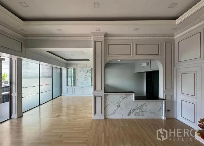 Office Space for rent in Prawet, Bangkok - Open-plan lobby area with floor-to-ceiling frosted glass panels and marble reception counter.