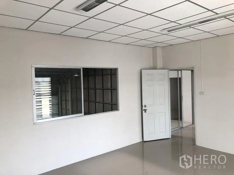Factory for rent in Pak Kret, Nonthaburi - Bright upstairs office with window overlooking the production floor.