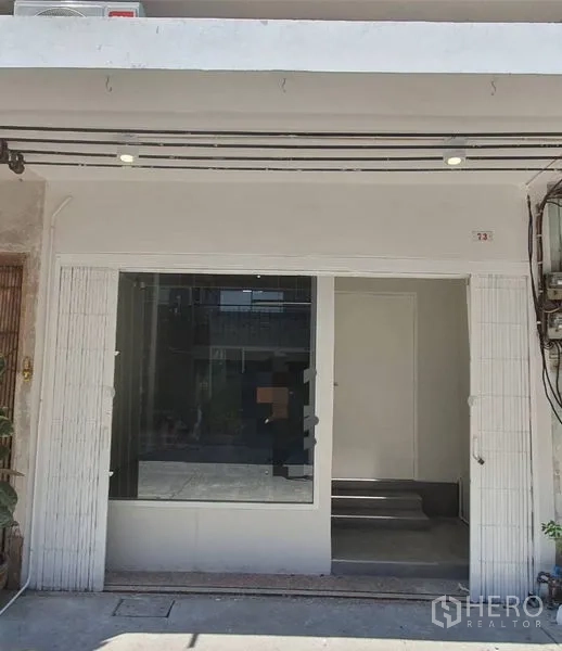 อาคารพาณิชย์ ให้เช่าในPhra Khanong, Bangkok - ด้านหน้าร้านโทนขาวสะอาด มีกระจกโชว์บานใหญ่และทางเข้ายกระดับเล็กน้อย