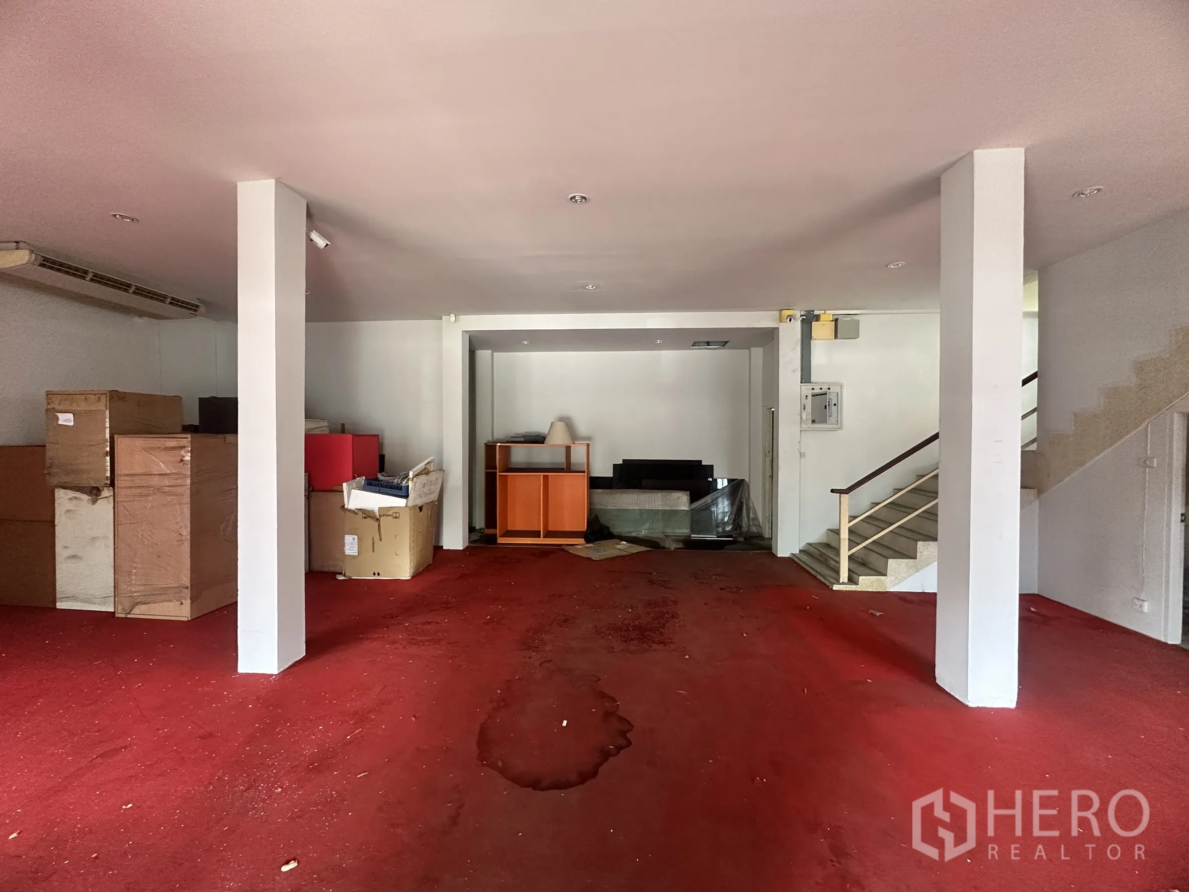 Factory for sale in Bang Bua Thong, Nonthaburi - Another view of the red-carpeted office area with boxes and built-ins.