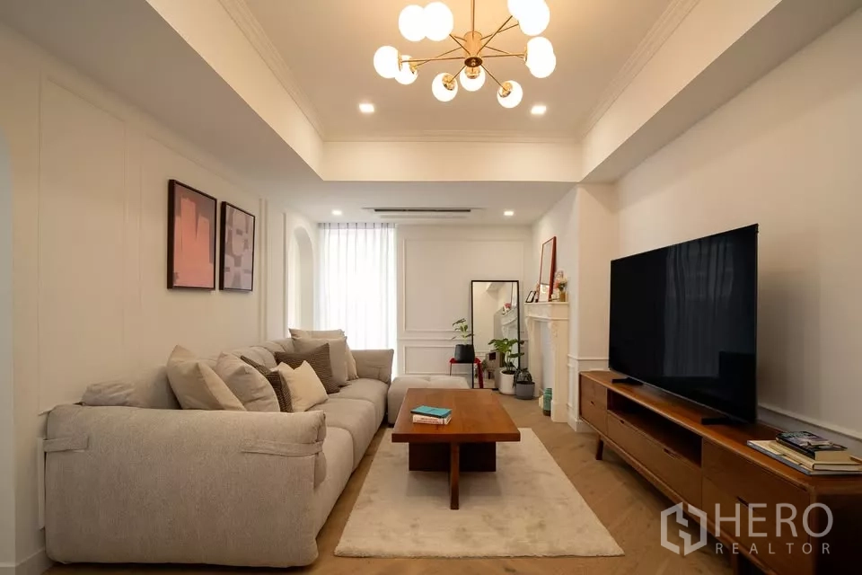 คอนโด ขายในWatthana, Bangkok - ห้องนั่งเล่นสว่างในคอนโดวัฒนา โซฟาขนาดใหญ่ ตู้วางทีวีไม้ โคมไฟโมเดิร์น