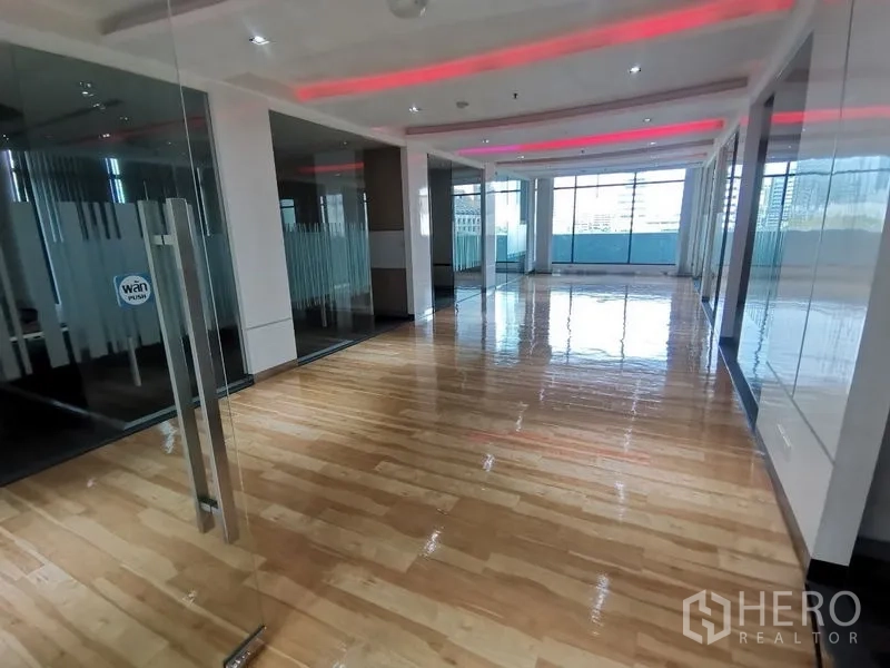Office Space for rent in Bang Rak, Bangkok - Bright open-plan office with glossy wooden floor, glass partitions and large windows with city views.