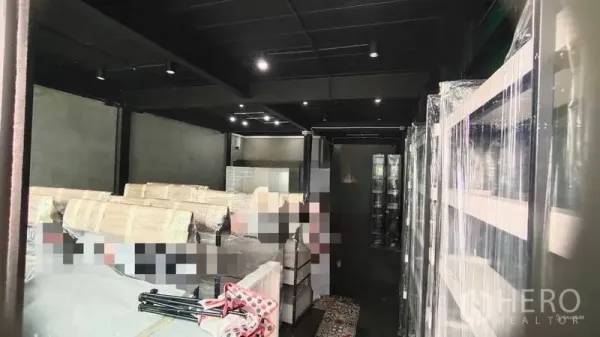 Shophouse for rent in Bang Kho Laem, Bangkok - Open-plan interior featuring black ceiling, track lighting and display shelving.