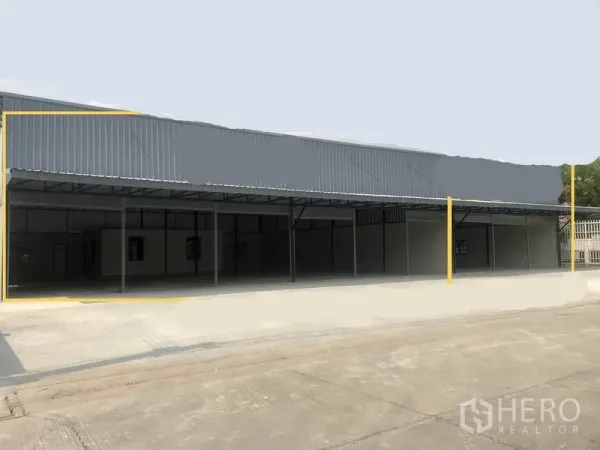 Warehouse for rent in Pathum Thani - Street-facing row of metal-clad warehouses with wide driveway and covered loading bays.