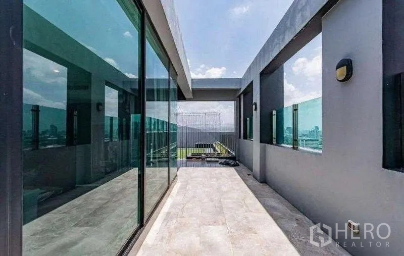 Condominium for rent - Private terrace with glass balustrades and wide city views.