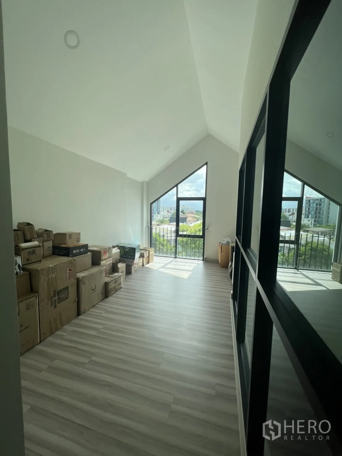 Home Office for rent or sale in Phra Khanong, Bangkok - Top-floor storage or studio with gable windows and abundant light.