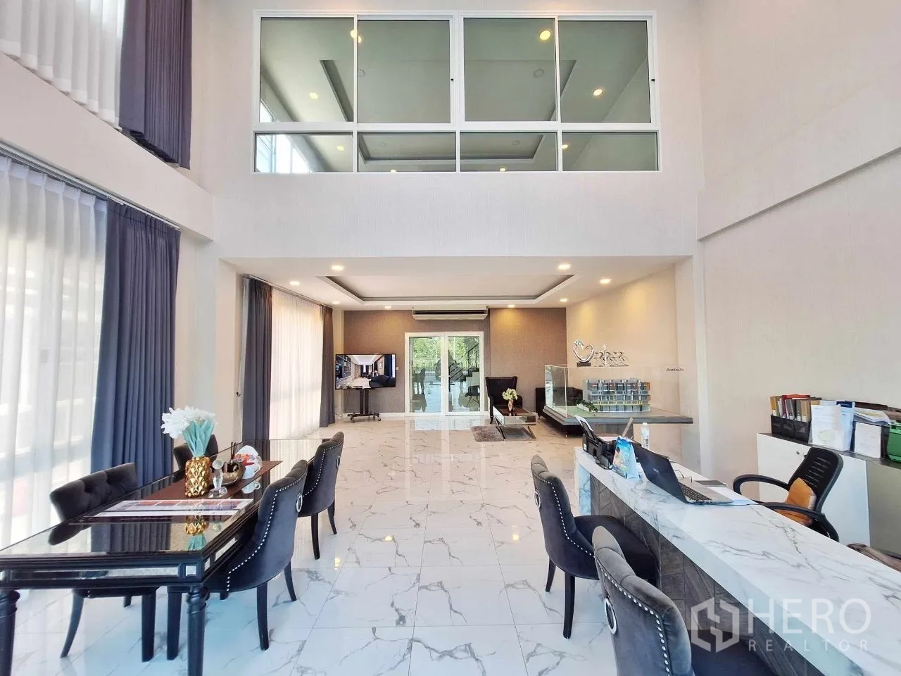 Home Office for sale in Bueng Kum, Bangkok - Double-height lobby of the home office with marble floors, tall windows and reception desks.