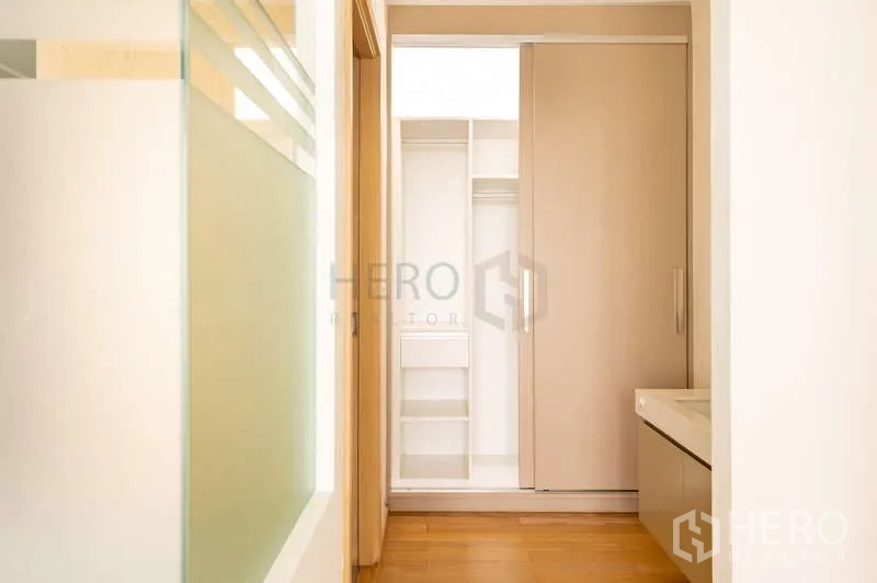 Condominium for sale in Khlong Toei, Bangkok - Hallway leading to a built-in sliding wardrobe and dressing area.