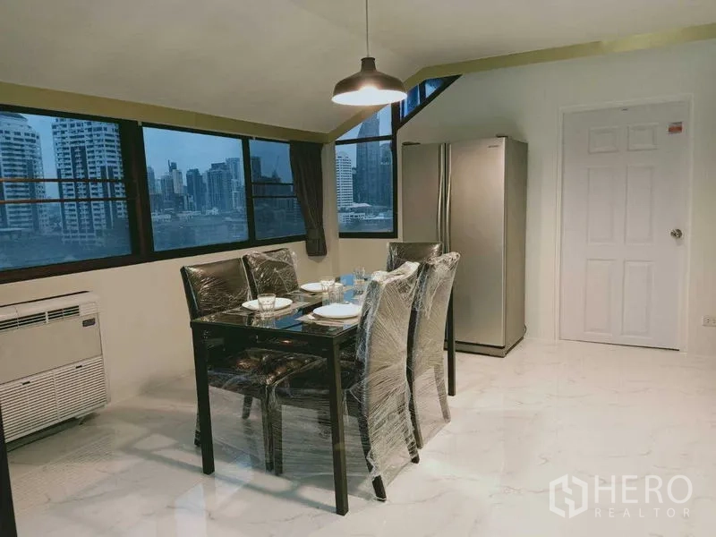 Condominium for  in Watthana, Bangkok - Dining corner with pendant light, city views and double-door refrigerator.