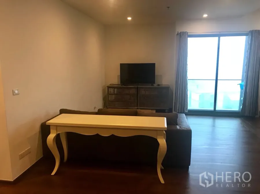 คอนโด ให้เช่าในKhlong Toei, Bangkok - ห้องนั่งเล่นพื้นไม้ มีโซฟา ตู้ทีวี และประตูกระจกบานเลื่อนออกระเบียง