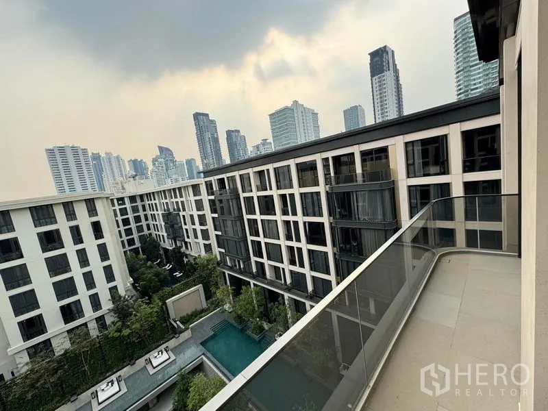 Condominium for rent in Watthana, Bangkok - Private balcony overlooking pool courtyard and Bangkok skyline.