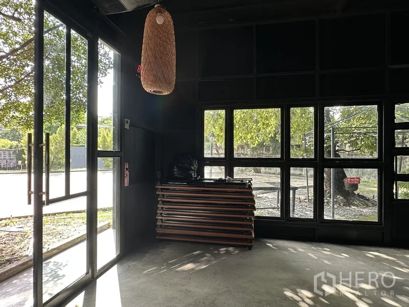 Retail Space for rent in Phra Khanong, Bangkok - Glass entrance and floor-to-ceiling windows with rattan pendant light inside.