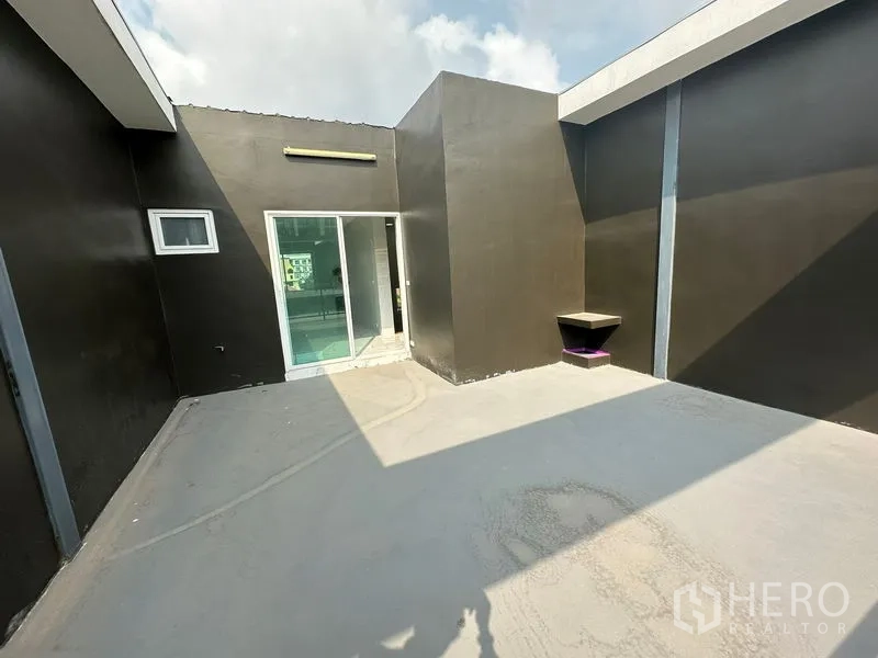 Home Office for rent or sale - Rooftop terrace with sliding door access and high parapet walls under open sky.