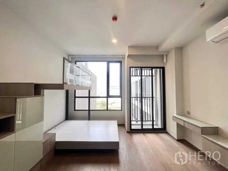 Condominium for sale - Another view of the bedroom showing platform bed, big window and balcony access with city outlook.